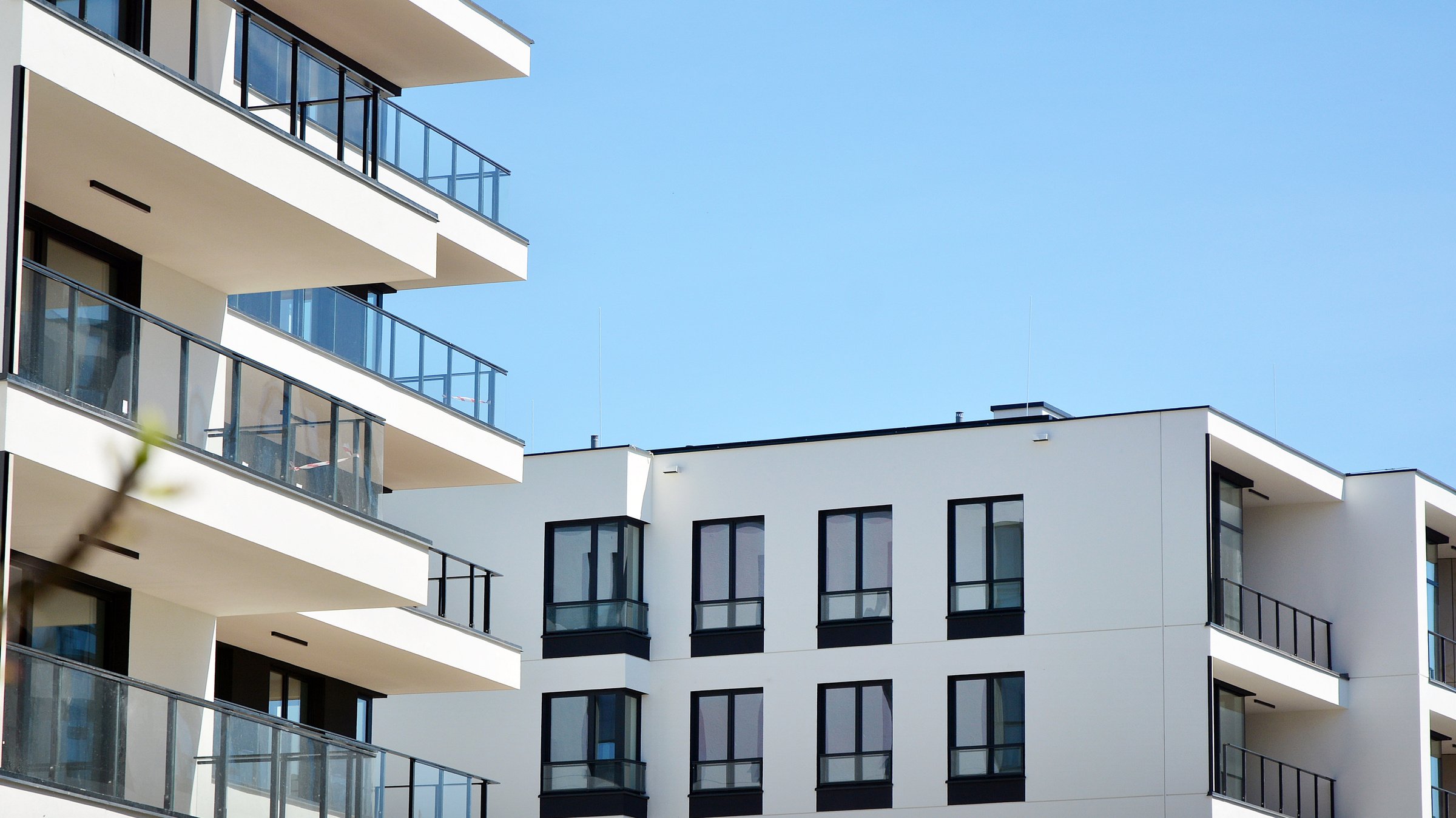 Modern condo building with big windows and modern facade.